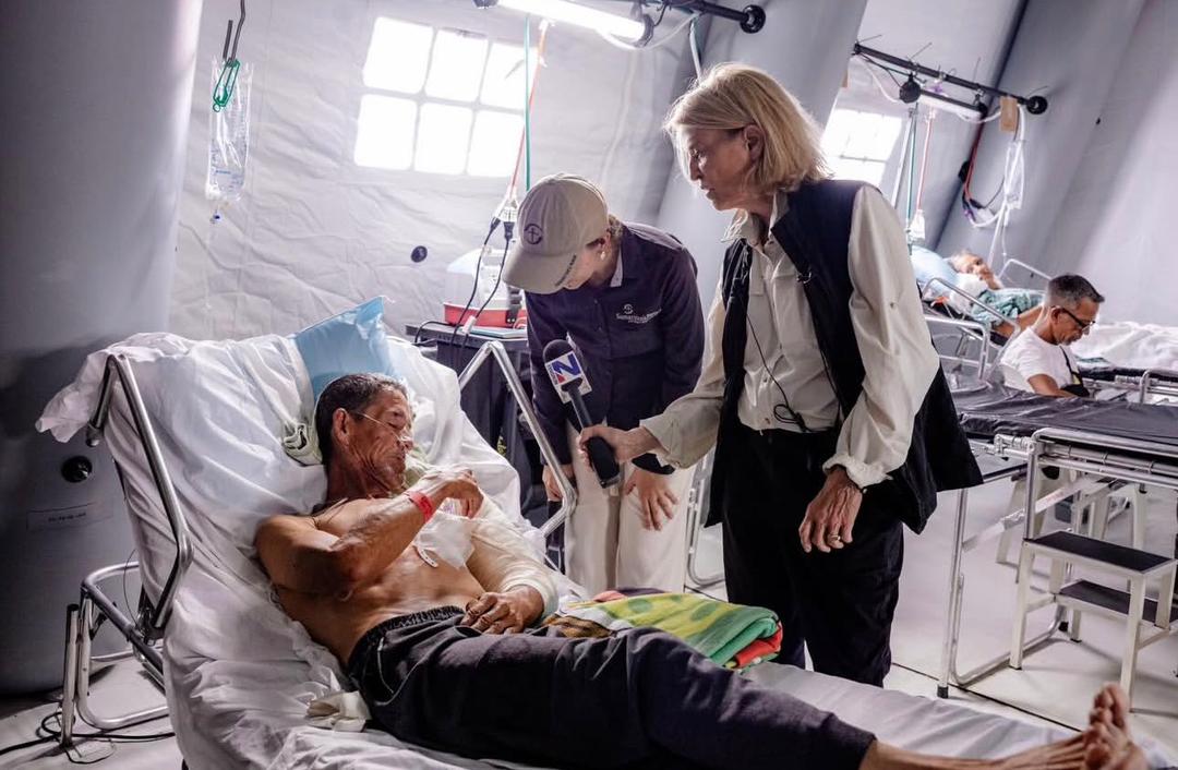 A patient recovering on a hospital bed inside an inflatable emergency field hospital ward